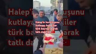 Halep'in kurtuluşunu kutlayan halepliler türk bayrağı açarak tatlı dağıtıyor.