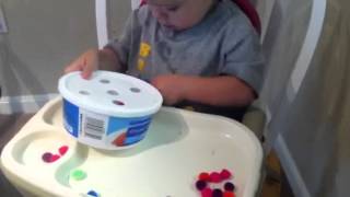 Toddler fine motor - Pom poms in holes