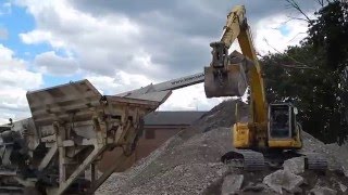 Kobelco 235SR Excavator Loading a Nordberg LT1213 Crusher with Concrete