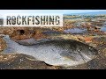 fishing on rocks with fishing rod and hand line