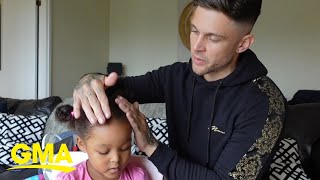 Dad doing his daughter's hair is too cute to watch