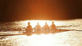 stock footage oarsmen in training on the water at sunrise seen in silhouette 1