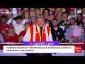 trump makes crowd laugh with extended riff about wearing trash collector vest to rally in green bay