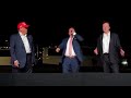 Trump & Elon stand awkwardly while guy sings