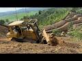 Terrible job! CAT D6R XL bulldozer cuts through the cliffs of a mysterious mountain