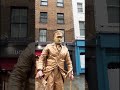 how gold man statue is getting into his position beats by silverman statue