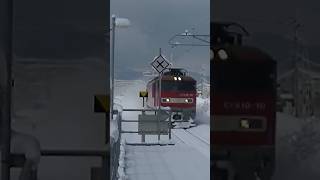 雪けむりをあげながら疾走する貨物列車