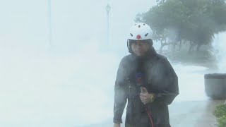 Typhoon Hato: TV reporter knocked off his feet by wave