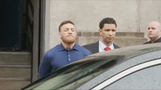 UFC fighter Conor McGregor escorted by police from court