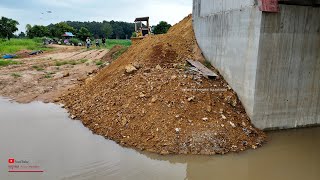 Clear And Filling In Space Bridge Construction And Komatsu Dozer Pushing SoilsRock With Dump Trucks