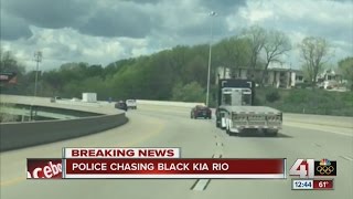 Police chasing black Kia Rio