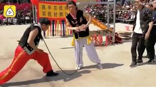 Chinese Kung Fu master bends a reinforced steel bar by pointing it against his THROAT