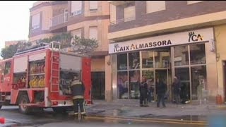 Woman sets herself alight in Spanish bank