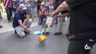 Protesters burn masks outside City Hall in response to mask mandate