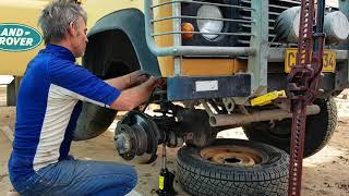 Land Rover Defender suspension replacement on the road at campsite, Baja peninsula, Mexico.