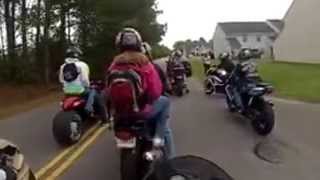 Girl falls off motorcycle and gets stuck on tire on