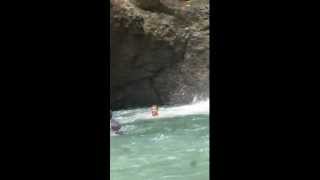 John jumping at the waterfall in Fiji on the Feejee Experience