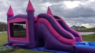 Deflate and roll up the pink waterslide bounce house 7 in 1 combo