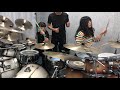 two chinese girl play fancinating drum set rain in march