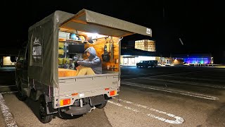 Sleeping on the roadside in the bed of a small truck