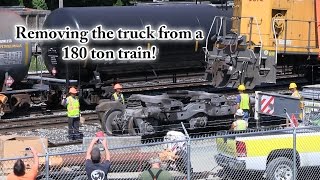 Removing a wheel truck from a 180 ton train locomotive (engine) with a crane!