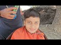 youngest barber cutting hair of an innocent boy