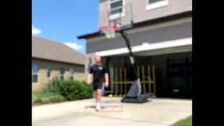 Guy dunks and  basketball hoop falls over