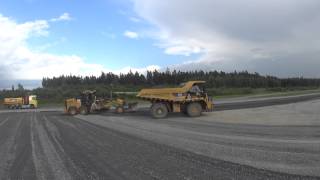 Cat 770 truck spreading gravel