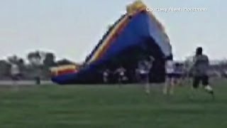 2 hurt after bouncy slide flies away