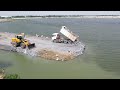 awesome 18ton trucks dumping stones shantui dozer pushing stones build road across the water