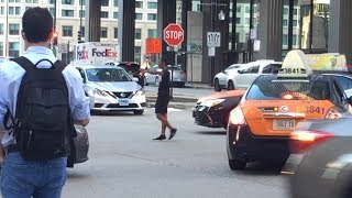 Guy plays traffic cop in busy intersection [FUNNY]