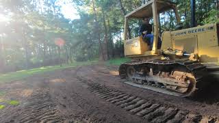 John Deere 450G | Pushing brush piles into woods