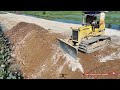 perfectly komatsu d31p bulldozer pushing soil and 5ton dump trucks land fill the gap widen the road