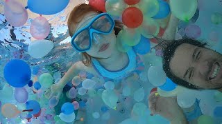 Swimming in 1,000 WATER BALLOONS!!  Playing in the Pool and family Helicopter Ride at pirate island!