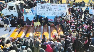 Families block road, bury bodies after bloody Guatemala village attack | AFP