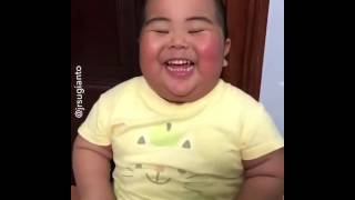 Little asian boy laughs funny