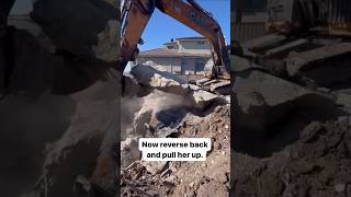 Pulling up a concrete slab on a Home Demolition Project #demolition #constructionproject #excavator