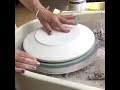 Using the pottery wheel to throw dinner plates on plaster forms.