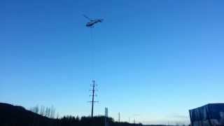 Helicopter strings power cable in Alaska
