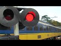 train passes by very quickly at railroad crossing spoorwegovergang in bilthoven