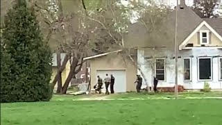 Police in SWAT gear surround a home in Shenandoah