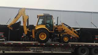 BACKHOE LOADER CM870A(WZ30-25) on a flatbed truck Moving to the right position for rope fixing