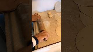 Rolling Poori with a wooden rolling pin