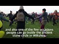 crowds of people gather at stonehenge to mark the winter solstice