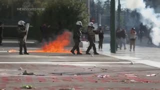 Greek police clash with protesters outside parliament during debate on private universities