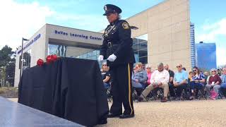 Officers place roses at the Police Memorial Service in Grand Rapids