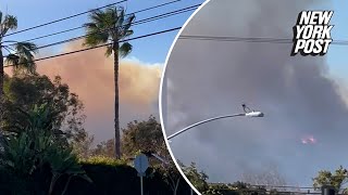 LA residents flee wildfire as potentially ‘life-threatening, destructive’ winds gain strength