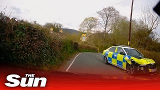 Moment stolen police car crashes into hedge