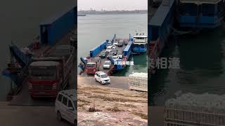 Large trucks are getting off the boat and landing. Ferry crossing the river. Car ferry crossing