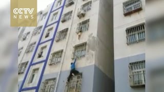 Man climbs building with bare hands to save child hanging outside window in east China